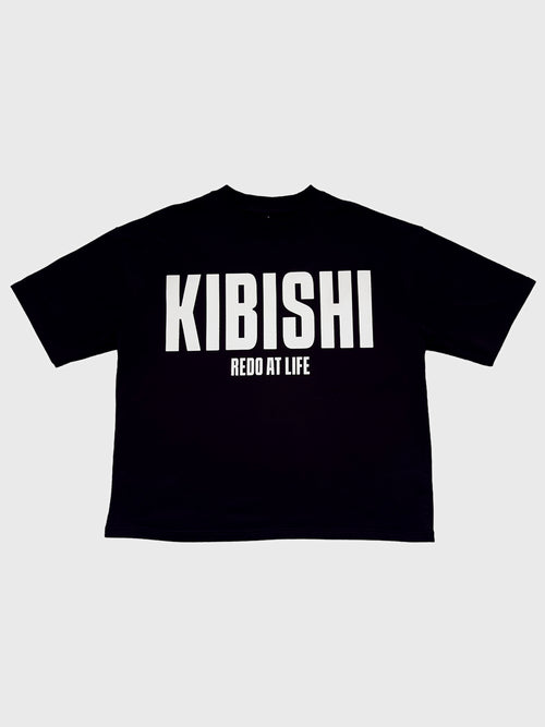 Front of the Redo at Life t-shirt by KIBISHI — black oversized tee with bold white 'KIBISHI' and 'Redo at Life' text graphic on the chest.